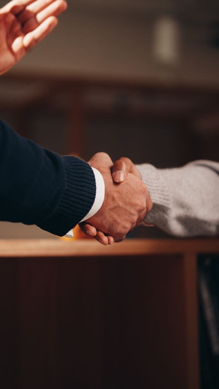 A close handshake sealing an owner and operator agreement