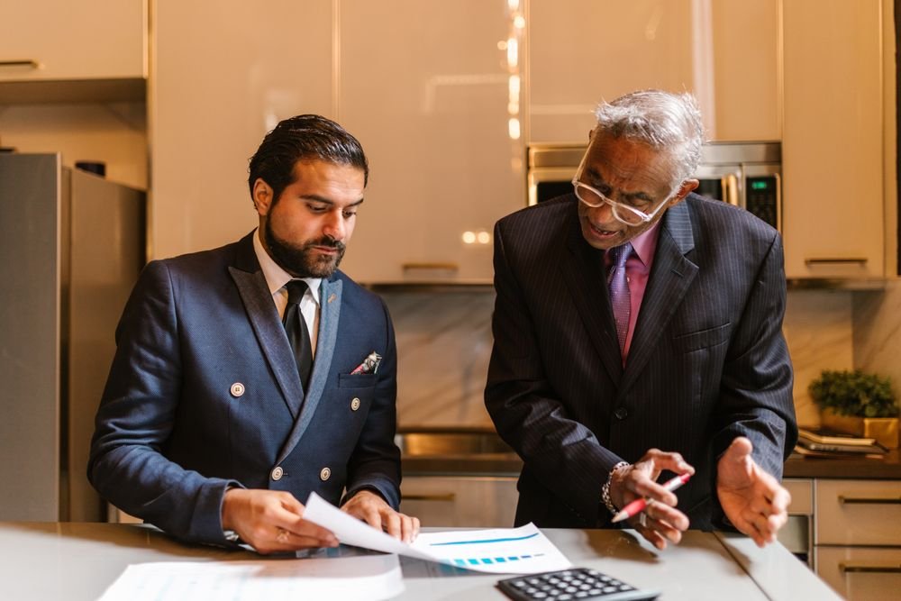 Two finance professionals reviewing financial documents together at a desk