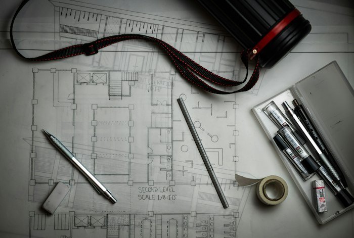 An architectural blueprint with drafting tools