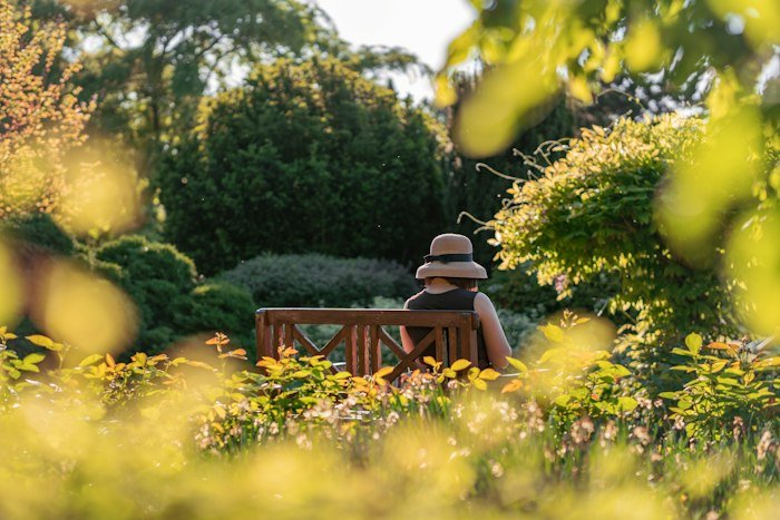 A resident resting on a garden bench